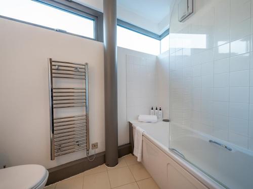 a bathroom with a tub and a toilet and a sink at Modern flat a short walk from Shrewsbury centre - Pass the Keys in Shrewsbury