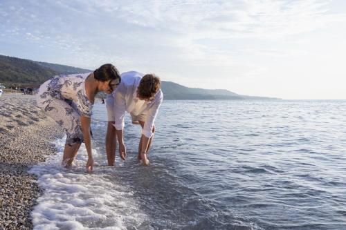 two women playing in the water at the beach at Park Oasi Resort in Zambrone