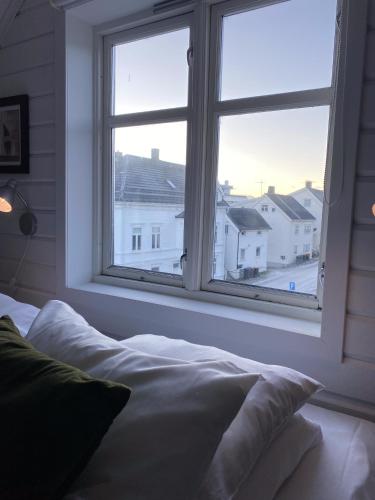 a bedroom with a window with a view of a city at Enter Tromsø - Exclusive Apartments in Tromsø