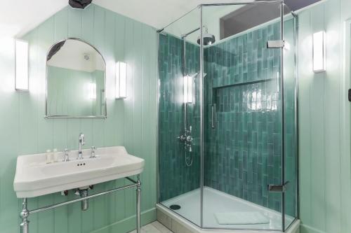a bathroom with a sink and a glass shower at 1 Chestnut Corner in Stanton
