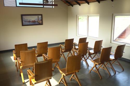 a room with a table and chairs in it at Vaidekam Resorts & Wellness, Kannur in Kannur