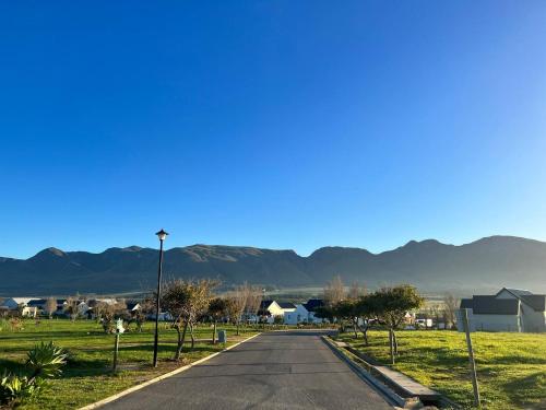 an empty road with mountains in the background at A Mountain & Country Haven in Stanford