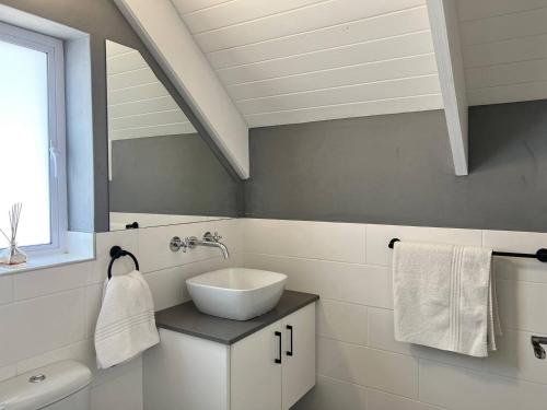 a white bathroom with a sink and a mirror at A Mountain & Country Haven in Stanford