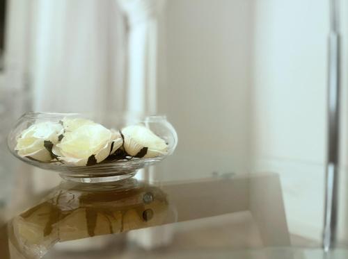 a glass vase filled with white flowers on a table at Place Sainte Marguerite in Provins