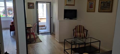 凱澤貝爾的住宿－Gîte Le Patio，客厅配有两把椅子和电视