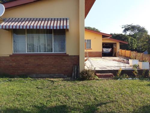 a house with a deck in the yard at Solitaires BnB in Durban