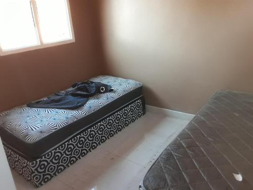 a bed in a corner of a room at Solitaires BnB in Durban
