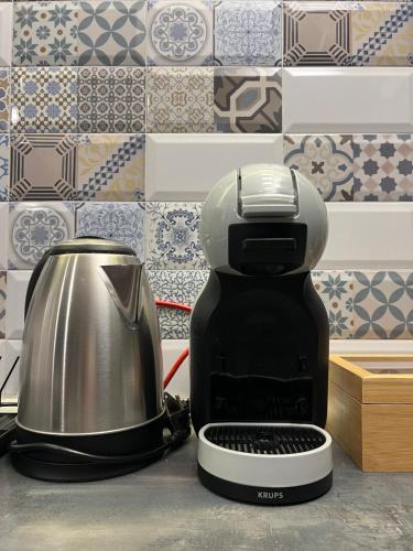 a coffee maker sitting on a counter next to a toaster at City Garden Studio in Plovdiv