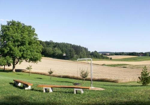 a park with two benches and a street light at Hof am Horn - Fewos in der Natur in Laichingen