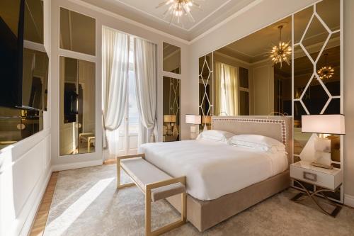 a bedroom with a large white bed and a window at Grand Hotel Principe Di Piemonte in Viareggio