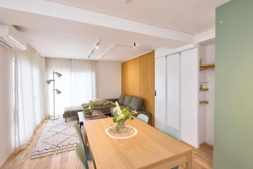 a living room with a table and a couch at BANBOO HOUSE in Osaka
