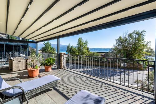 an outdoor deck with a view of the water at Residence Virgilio Green in Toscolano Maderno