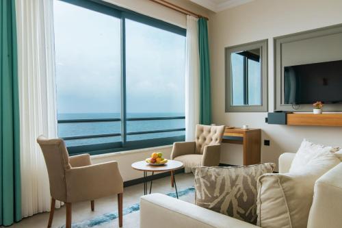 a living room with a view of the ocean at Fevzi Hoca Otel in Trabzon
