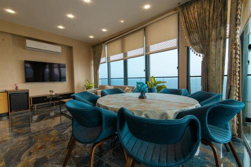 a meeting room with a table and blue chairs at Fevzi Hoca Otel in Trabzon