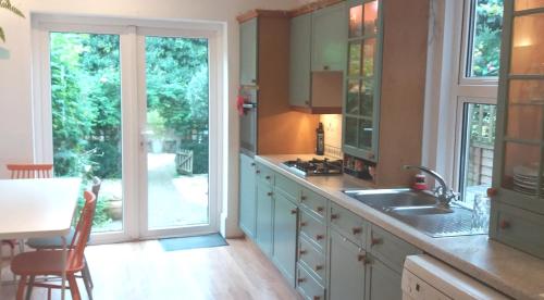 a kitchen with a sink and a counter with a window at Victorian Terraced House in Salisbury; 3 bedrooms in Salisbury