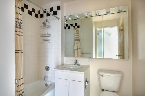 La salle de bains est pourvue de toilettes, d'un lavabo et d'un miroir. dans l'établissement UES 2br w elevator doorman nr transportation NYC-1297, à New York