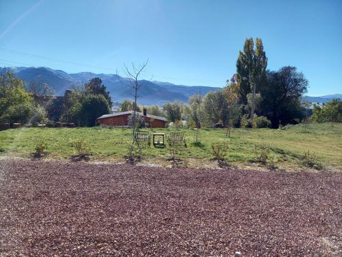 a field with a house in the background at Eco-Logis des Cabris in Font-Romeu