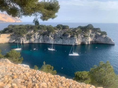 a small island with boats in the water at Duplex au cœur du village de Cassis in Cassis