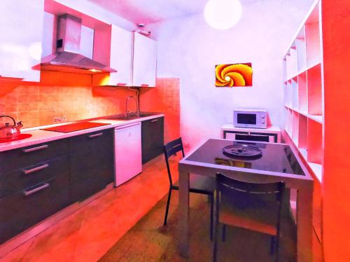 a kitchen with a small table and a stove at L' appartamento sul Naviglio in Milan