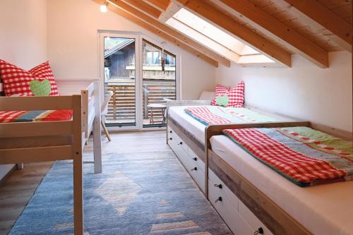 a room with two bunk beds and a window at Luginsland in Sonthofen