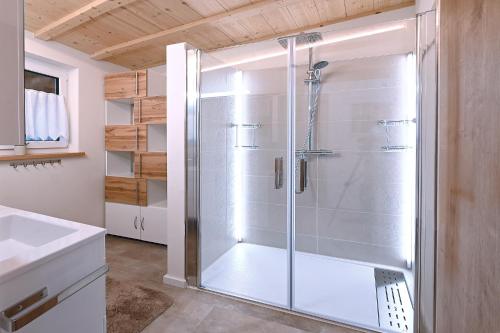 a shower with a glass door in a bathroom at Luginsland in Sonthofen