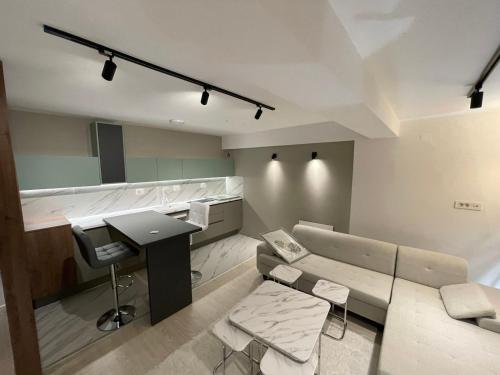 a room with a desk and a table and a couch at Skopje Kale Luxury Apartment in Skopje