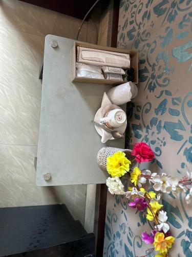 a locker with flowers on it with a drawer at Hotel Siddarth Palace in Mangaldai