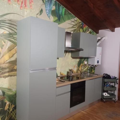 a kitchen with a refrigerator and a sink at D e c a d e n c e -Wine calling! in Rovato