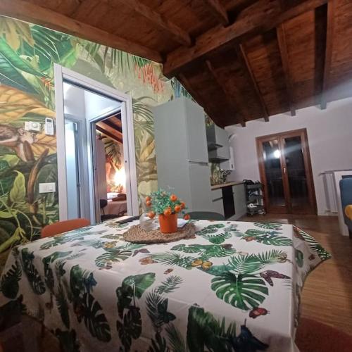 a bedroom with a bed with a tropical print on it at D e c a d e n c e -Wine calling! in Rovato