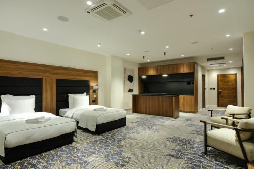 a hotel room with two beds and a flat screen tv at Hotel Vema in Visoko