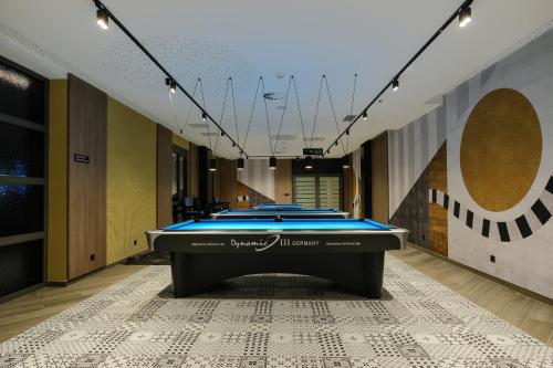 a pool table in the middle of a room at Hotel Vema in Visoko