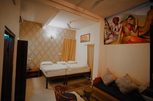 a room with two beds and a painting on the wall at KARNI VILAS in Jaipur