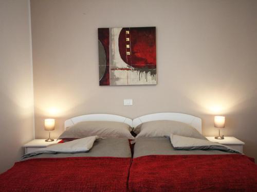 a bedroom with a large bed with two lamps at Apartment with balcony Hiša Brdo 48 in Bovec