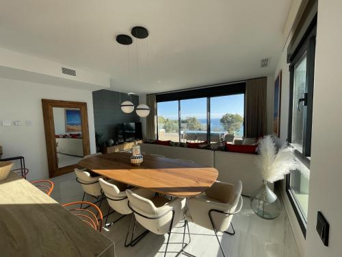 a dining room with a wooden table and chairs at Luxury Sea View Penthouse by United Renters in Villajoyosa