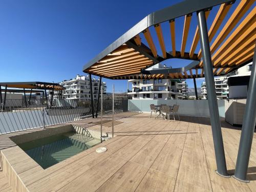 a rooftop deck with a pool and a wooden floor at Luxury Sea View Penthouse by United Renters in Villajoyosa