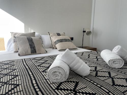 two beds with towels on top of them in a bedroom at Luxury Sea View Penthouse by United Renters in Villajoyosa
