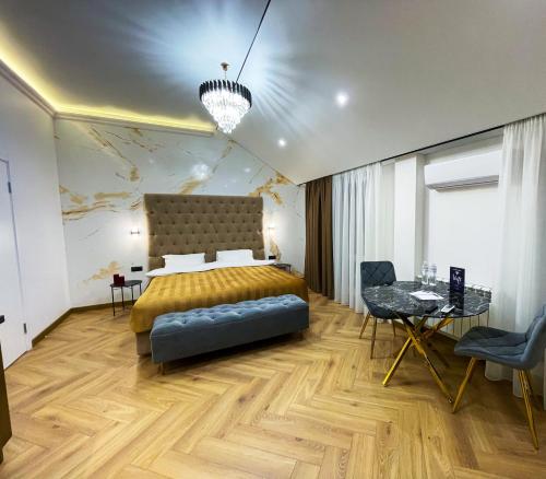 a bedroom with a bed and a table and chairs at LUX Апартаменти MYFREEDOM поруч метро Театральна, Хрещатик in Kyiv