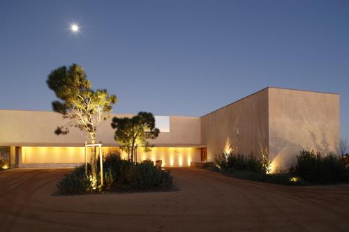 a building with lights on the side of it at Praia do Canal Nature Retreat - Small Luxury Hotels of the World in Aljezur