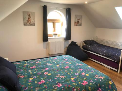 a bedroom with a bed and a window at Lakeside Loft in Hereford