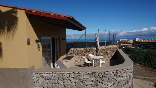 a building with a patio with a table and chairs at Tantulia Las Tapias Tenerife in Puerto de la Cruz