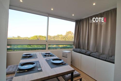 une salle à manger avec une table et une grande fenêtre dans l'établissement SAMOA - 4 COUCHAGES, à Sausset-les-Pins