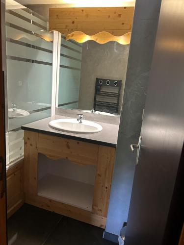 une salle de bain avec un lavabo et un miroir dans l'établissement La Turra 510 - Appt moderne - 4 pers, à Modane