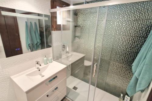 a bathroom with a shower and a sink and a mirror at Olivia Sunny 2 bedroom Apartament Punta Prima in Torrevieja