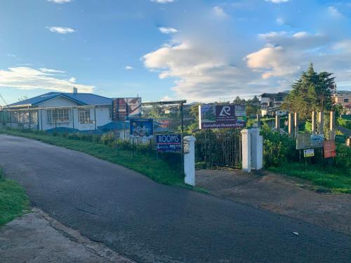 an empty street with signs on the side of the road at Aaradhya Nuwara Eliya in Nuwara Eliya
