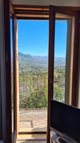 a room with a sliding glass door with a view at La collina degli ulivi in Conocchia