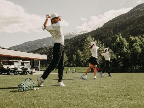 a group of people playing with soccer balls in a field at Boutique Hotel Haidachhof superior in Fügen