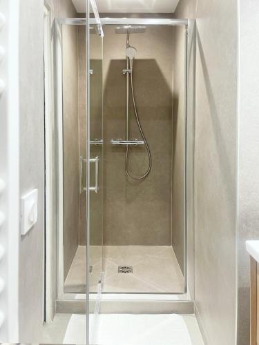 a shower with a glass door in a bathroom at Place Sainte Marguerite in Provins