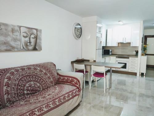 a living room with a couch and a table at Casa Royal Los Cristianos Center in Los Cristianos