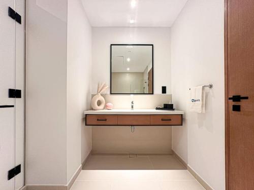 a bathroom with a sink and a mirror at HiGuests - High Level Luxury Apartment With Marina Views in Dubai