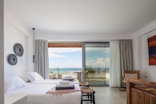 a bedroom with a bed and a view of the ocean at Feyre Boutique Mansion in Magnisía